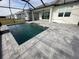 Newly built pool with gray pavers and a screened enclosure at 1119 Waterline Ct, Sarasota, FL 34240