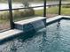 Relaxing pool with a waterfall feature and a lake view at 1119 Waterline Ct, Sarasota, FL 34240