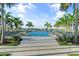 Community resort-style pool with lounge chairs and palm trees at 1119 Waterline Ct, Sarasota, FL 34240