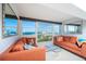 Spacious living room with water views and orange couches at 33 S Gulfstream Ave # 1007, Sarasota, FL 34236