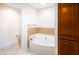 Bathroom with soaking tub and wood cabinets at 808 3Rd W Ave # 701, Bradenton, FL 34205