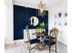 Modern dining area with a blue accent wall and gold details at 808 3Rd W Ave # 701, Bradenton, FL 34205