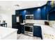 Modern kitchen with blue cabinets, white countertops, and stainless steel appliances at 808 3Rd W Ave # 701, Bradenton, FL 34205