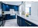 Stylish kitchen boasting blue cabinetry, white countertops, and farmhouse sink at 808 3Rd W Ave # 701, Bradenton, FL 34205