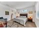 Comfortable bedroom with hardwood floors, a king-size bed, and en-suite bathroom at 2563 Prospect St, Sarasota, FL 34239
