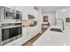 Well-equipped kitchen with white cabinets, stainless steel appliances, and quartz countertops at 2563 Prospect St, Sarasota, FL 34239