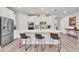 Modern kitchen features white cabinetry, stainless steel appliances, and breakfast bar at 2563 Prospect St, Sarasota, FL 34239