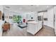 Open concept kitchen boasts white cabinets, quartz countertops, and island with seating at 2563 Prospect St, Sarasota, FL 34239