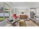 Spacious living area with hardwood floors, comfortable seating, and view of backyard at 2563 Prospect St, Sarasota, FL 34239