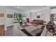 Bright living room with hardwood floors, modern furniture, and sliding glass doors leading to backyard at 2563 Prospect St, Sarasota, FL 34239