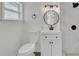 Modern bathroom with white vanity, marble shower, and round mirror at 1054 W Baffin Dr, Venice, FL 34293