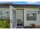 Inviting house entrance with open door, showing a glimpse of the interior and a welcome mat at 1054 W Baffin Dr, Venice, FL 34293