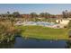 Community pool with lounge chairs and tennis courts nearby at 1423 57Th W St # 1423, Bradenton, FL 34209