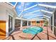 Inviting kidney shaped pool with screened enclosure at 4449 Greenfield Ave, Sarasota, FL 34233