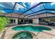 Inviting screened-in pool featuring a jacuzzi, a bar, and comfortable lounge areas for relaxation at 8019 Royal Birkdale Cir, Lakewood Ranch, FL 34202