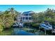 Waterfront home showcasing a private dock and beautiful landscaping at 5309 Hidden Harbor Rd, Sarasota, FL 34242