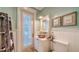 Quaint bathroom with a vessel sink and access to a private patio at 5309 Hidden Harbor Rd, Sarasota, FL 34242