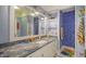 Fun bathroom with blue tile shower and granite countertop at 5309 Hidden Harbor Rd, Sarasota, FL 34242
