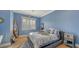 Blue themed bedroom with wood-paneled walls and a comfy bed at 5309 Hidden Harbor Rd, Sarasota, FL 34242