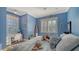 Blue themed bedroom with wood-paneled walls and a desk area at 5309 Hidden Harbor Rd, Sarasota, FL 34242
