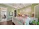 Charming bedroom with white wooden bed, soft color palette, and access to balcony at 5309 Hidden Harbor Rd, Sarasota, FL 34242