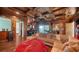 Game room features a sectional sofa, a wet bar, and access to an outdoor balcony at 5309 Hidden Harbor Rd, Sarasota, FL 34242