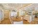 Bright kitchen with island, white cabinets, and hardwood floors at 5309 Hidden Harbor Rd, Sarasota, FL 34242