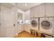 Laundry room with washer, dryer, and built-in cabinets at 5309 Hidden Harbor Rd, Sarasota, FL 34242