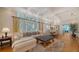 Spacious living room featuring a sectional sofa, a large ottoman, and hardwood floors at 5309 Hidden Harbor Rd, Sarasota, FL 34242