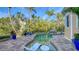 Inviting freeform pool with a spa, surrounded by a brick patio and lounge chairs at 5309 Hidden Harbor Rd, Sarasota, FL 34242