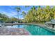 Large freeform swimming pool with a rock waterfall feature and plenty of space for lounging at 5309 Hidden Harbor Rd, Sarasota, FL 34242