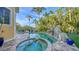 Luxury pool and spa with a rock waterfall, surrounded by lush landscaping at 5309 Hidden Harbor Rd, Sarasota, FL 34242