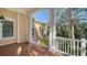 Covered porch with wooden floors, white columns, and access to the house at 5309 Hidden Harbor Rd, Sarasota, FL 34242