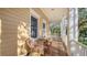 Relaxing porch with wicker chairs and a glass-top table, ideal for outdoor seating at 5309 Hidden Harbor Rd, Sarasota, FL 34242