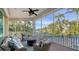 Peaceful screened porch overlooking canal and pool with wicker furniture at 5309 Hidden Harbor Rd, Sarasota, FL 34242