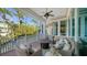 Relaxing screened porch with wicker furniture and tranquil backyard views at 5309 Hidden Harbor Rd, Sarasota, FL 34242