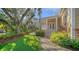 Landscaped side yard with a brick pathway leading to the house entrance at 5309 Hidden Harbor Rd, Sarasota, FL 34242