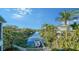 Stunning canal-front view with lush tropical landscaping and boats at 5309 Hidden Harbor Rd, Sarasota, FL 34242