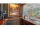 Custom wet bar featuring a wine rack and liquor storage at 5309 Hidden Harbor Rd, Sarasota, FL 34242