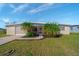 Ranch-style home with landscaped yard and screened porch at 258 Seminole Nw Blvd, Port Charlotte, FL 33952