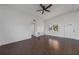 Living room with tile floors, ceiling fan, and view to kitchen at 258 Seminole Nw Blvd, Port Charlotte, FL 33952