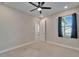 Bright bedroom featuring a ceiling fan and access to a bathroom at 4564 Almada Ln, Wesley Chapel, FL 33543