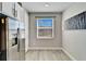 Stainless steel refrigerator in modern kitchen with white cabinets at 4564 Almada Ln, Wesley Chapel, FL 33543