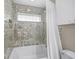 Bathroom with a shower/tub combo and tiled walls at 1358 Moonmist Dr # B4, Sarasota, FL 34242