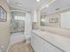 Clean bathroom, featuring a white vanity, bathtub, and tiled shower at 1358 Moonmist Dr # B4, Sarasota, FL 34242