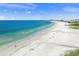 Expansive aerial view of a pristine beach with people enjoying the sun at 1358 Moonmist Dr # B4, Sarasota, FL 34242