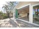 Home exterior featuring folding glass doors opening to patio at 1358 Moonmist Dr # B4, Sarasota, FL 34242