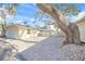 View of the home's garage and paved driveway with mature landscaping at 1358 Moonmist Dr # B4, Sarasota, FL 34242