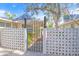Ornate gate entry with decorative block wall and lush landscaping at 1358 Moonmist Dr # B4, Sarasota, FL 34242