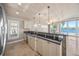 Open kitchen with island, water views, and stainless steel appliances at 1358 Moonmist Dr # B4, Sarasota, FL 34242
